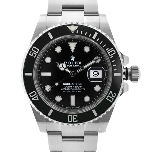 Closer image of a stainless steel wristwatch with a black dial, luminous hour markers, a date display at 3 o'clock, and black bezel. 