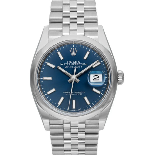 Up Close Image of a stainless steel wristwatch with a blue dial featuring luminous hour markers, a date display at the 3 o'clock position. The watch has a smooth bezel and a three-link bracelet.

